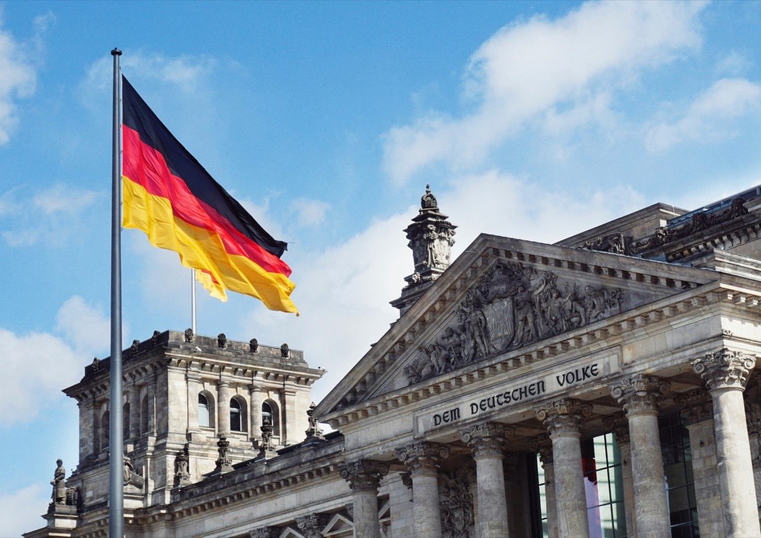 Study in Europe: the Reichstag building and German flag, Berlin