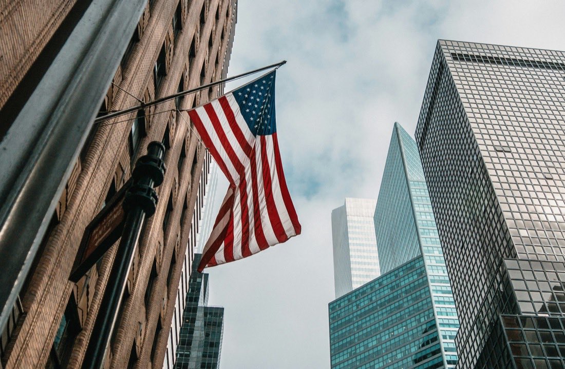 American flag among New York City skyscrapers, USA