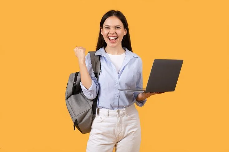 Excited student celebrating with a laptop and backpack